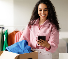 Woman holding phone close to the delivery package